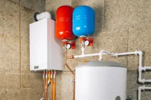 An image of a tanked water heater and a tankless water heater in a Southeast, ID home, highlighting water heater maintenance tips.